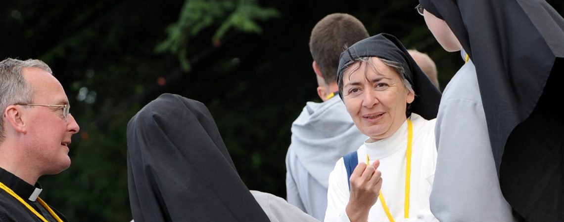 Priest talking with Nuns