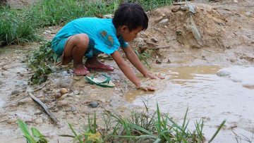 A-boy-looks-for-water-outside-a-camp-for-the-internally-displaced-in-northern-Myanmar-Burma