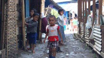 Children-between-shacks-in-a-camp-for-the-internally-displaced-in-northern-Myanmar-Burma