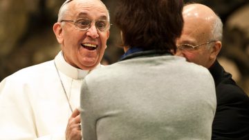 Pope-Francis-warmly-greets-a-woman-from-the-press-corps