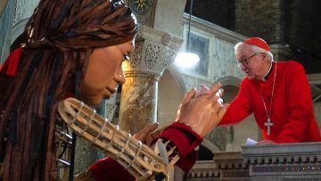 Little Amal, the puppet of a Syrian refugee girl, is welcomed to Westminster Cathedral
